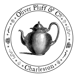 circle with black and white tea pot inside, with OP logo