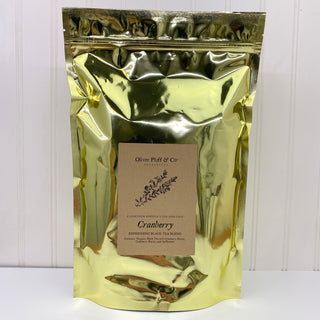 shiny gold tea bag pouch with OP label sitting on white kitchen counter