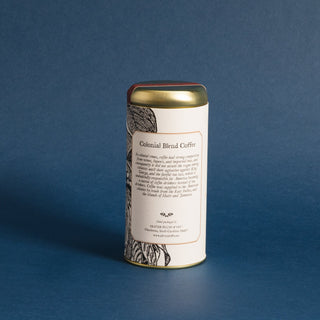 brewing instructions of gold tea tin with black and white flowery graphic. Blue background