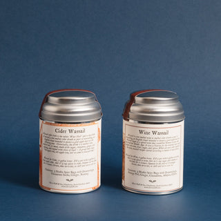 brewing instructions for two small silver tea tins with blue backdrop