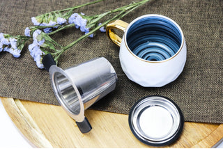 Stainless Steel Brewing Basket - for tea and coffee brewing, a white mug and purple flowers laying on wooden table