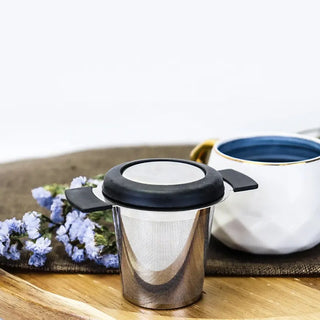 Stainless Steel Brewing Basket - for tea and coffee brewing, a white mug and purple flowers laying on wooden table