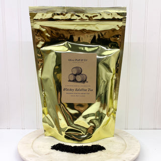 large shiny golden tea bag  on white counter