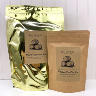 large shiny golden tea pouch and smaller brown tea pouch beside each other on white counter