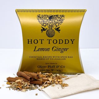 shiny yellow tea pouch with cinnamon sticks and dried tea leaves sprinkled in front