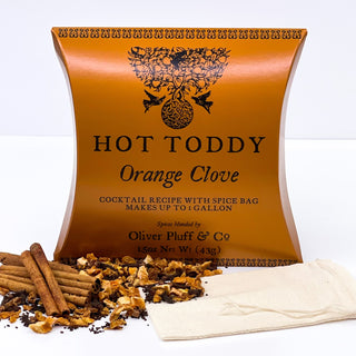 orange firm tea pouch with cinnamon sticks and loose leaf tea sprinkled in front