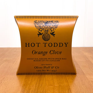 orange firm tea pouch sitting on wooden table 