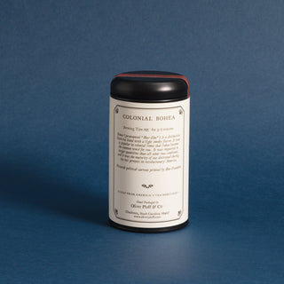  single black tea tin with brewing instructions against a blue background