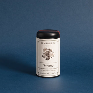 black tea tin with black and white flower on label