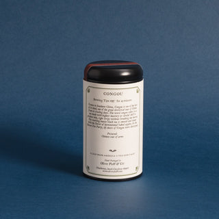 single black tea tin with brewing instructions against a blue background