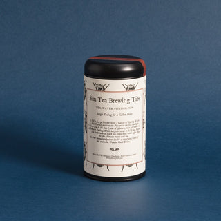 brewing instructions on black tea tin with black and white lady bug pattern on label