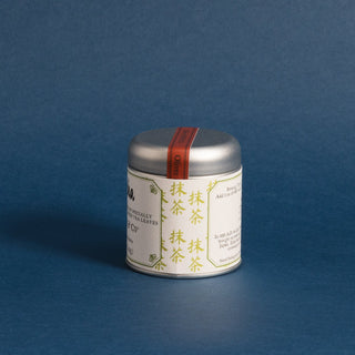 small silver tea tin with blue background