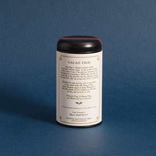 black tea tin with typed history  story on label against a blue backdrop