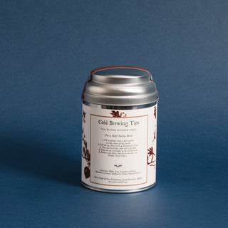 small silver tea tin against blue back ground