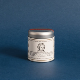 small silver tea tin with a black and white sketch of Martha Washington's face and brewing instructions against a blue background