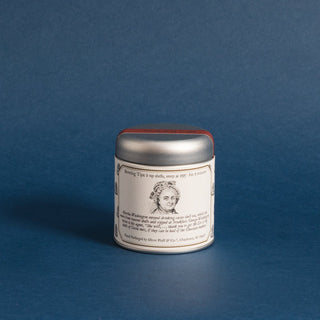 small silver tea tin with black and white sketch of Martha Washington against a blue backdrop