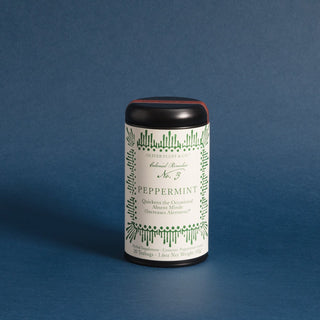 black tea tin with green dots and lines on the design label