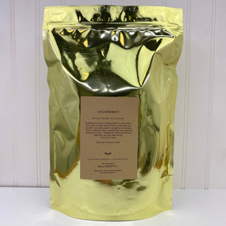 shiny gold tea bag pouch with OP label sitting on white kitchen counter