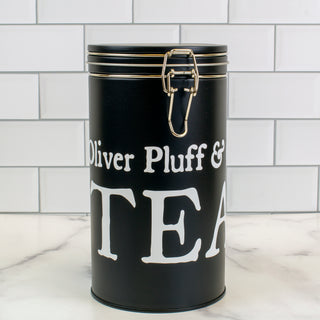 slim tall black latched tea tin with O.P. logo