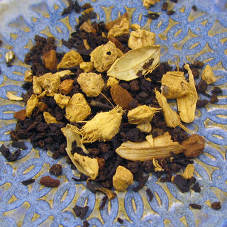 zoomed in view of yellow and dark colored masala chai tea leaves