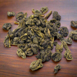 zoomed in view of loose leaf tea on wooden table