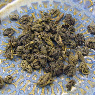 loose leaf tea sitting on blue and yellow plate