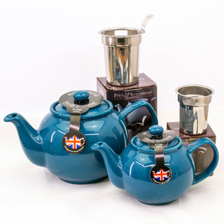 two blue teapots and stainless steel tea strainers