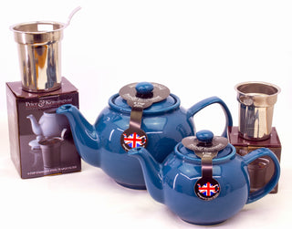 two blue tea pots and two tea filters sitting on top of packaging boxes