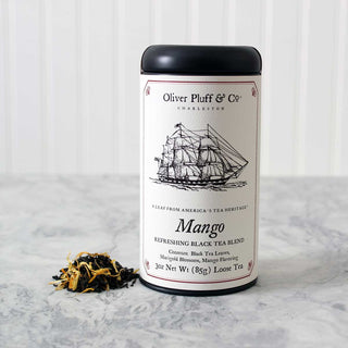 black tea tin with image of old timey ship on label sitting beside small pile of loose leaf tea on kitchen counter